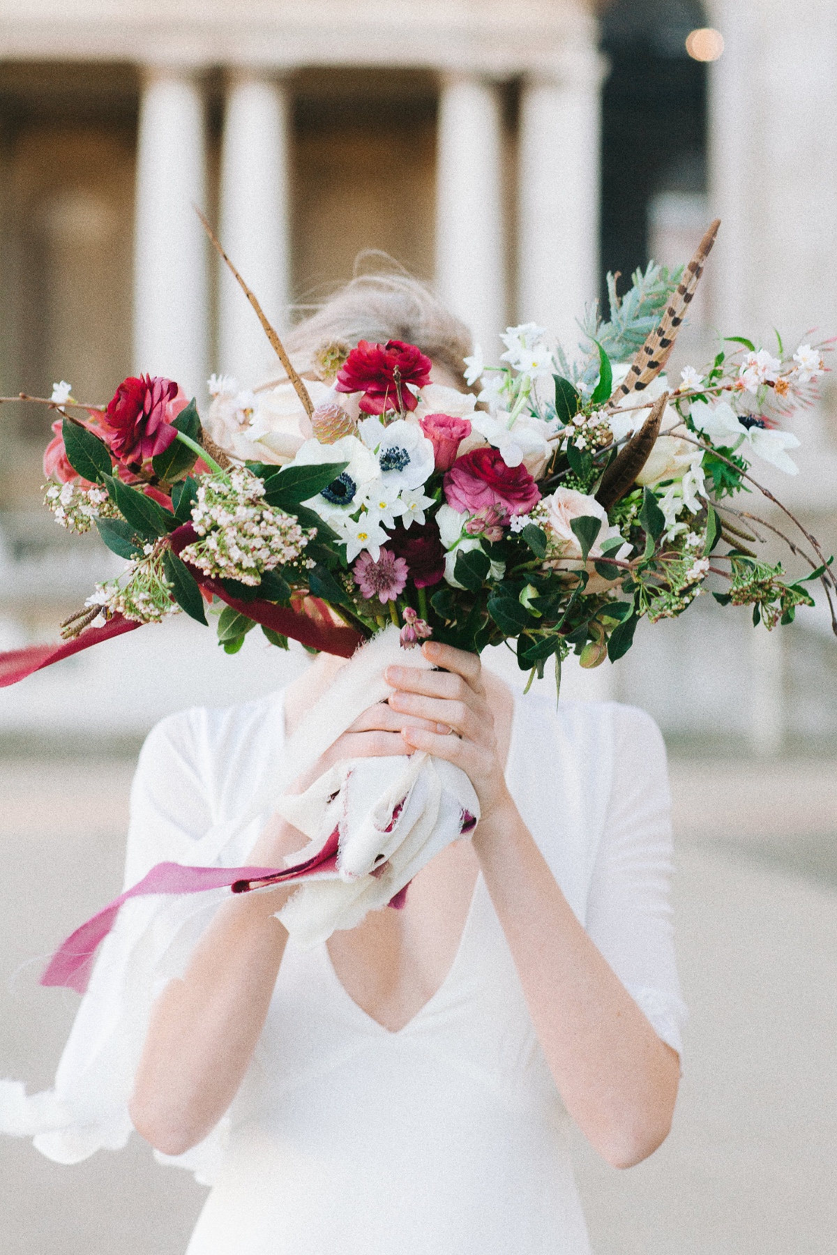 Bride holding a colorful floral bouquet wedding day