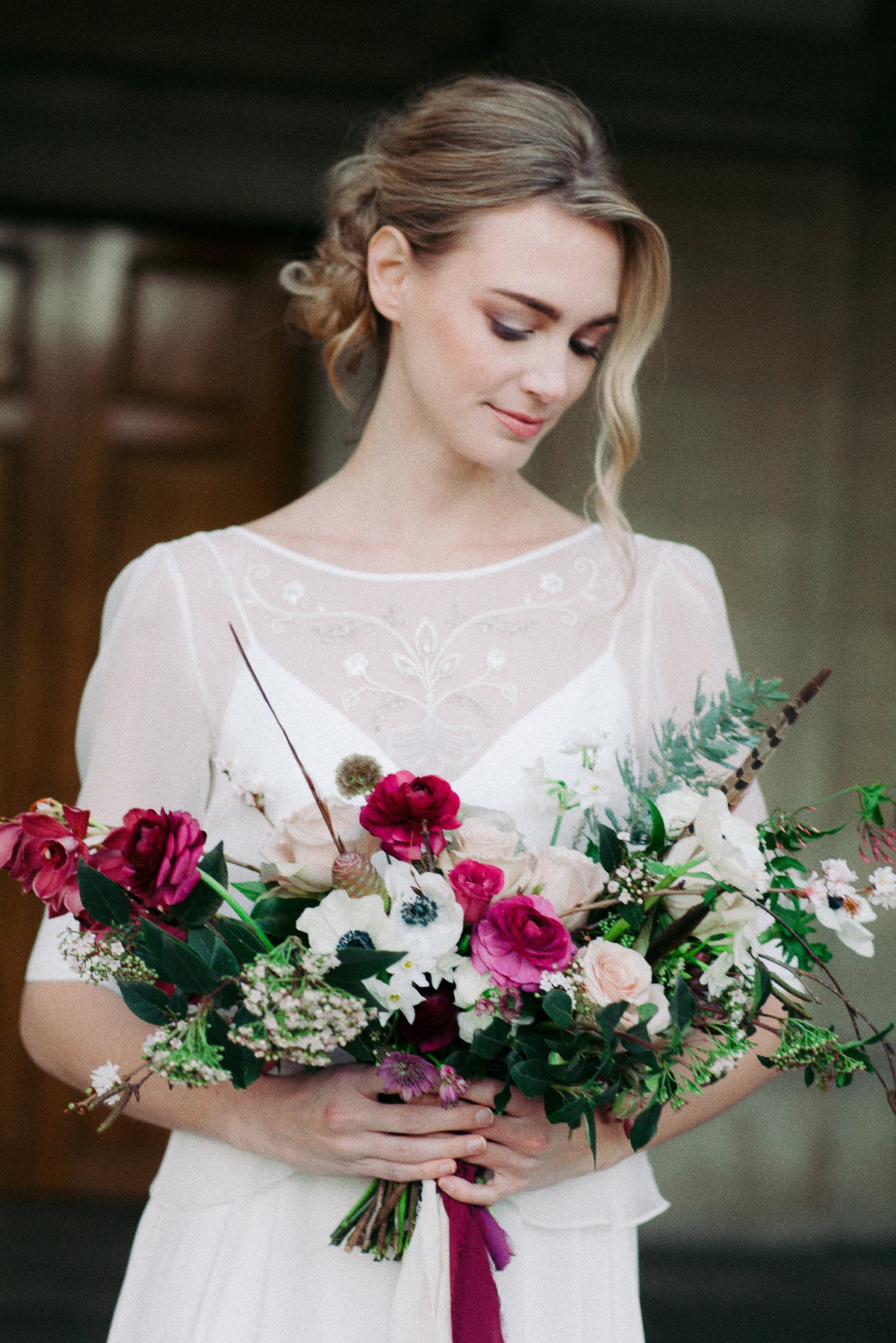 Beautiful bride with a lush colorful wedding bouquet
