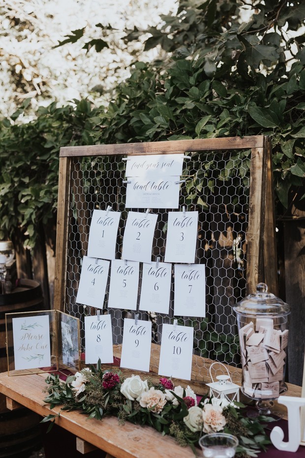 Elegant wedding seating chart with table numbers and floral decor