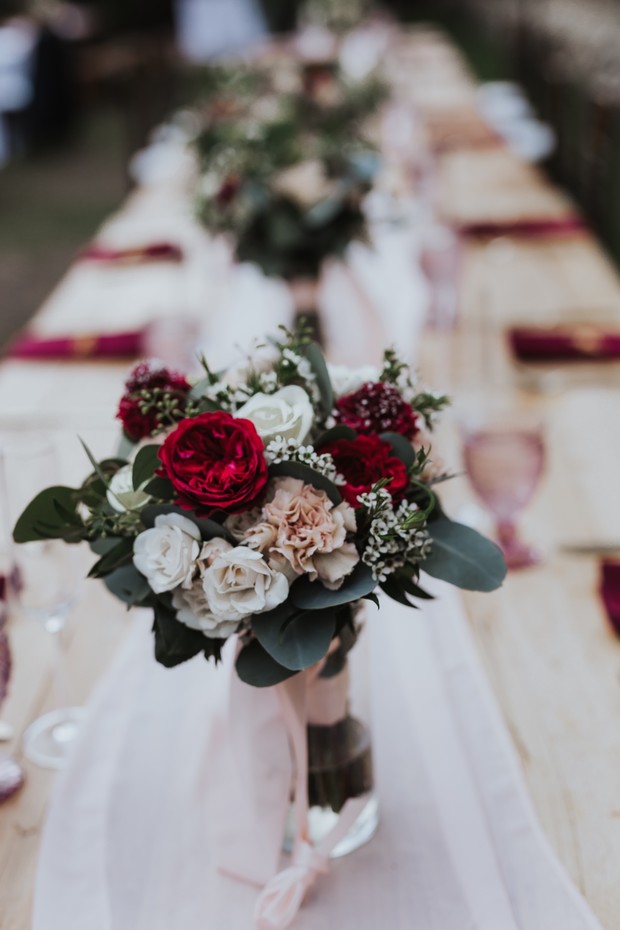Beautiful wedding bouquet in focus on a decorated table setting