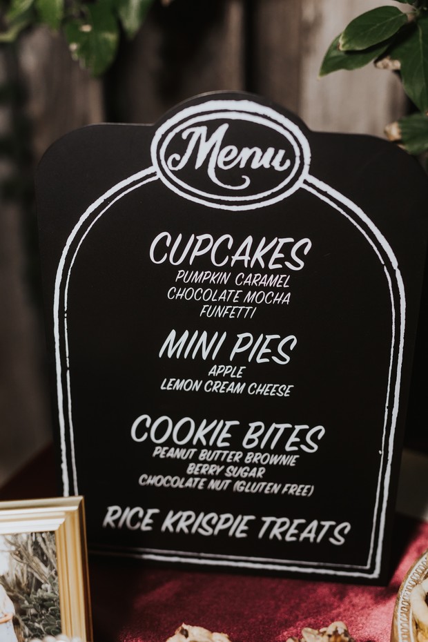 Handwritten menu board with cupcakes, mini pies, cookie bites, and rice krispie treats