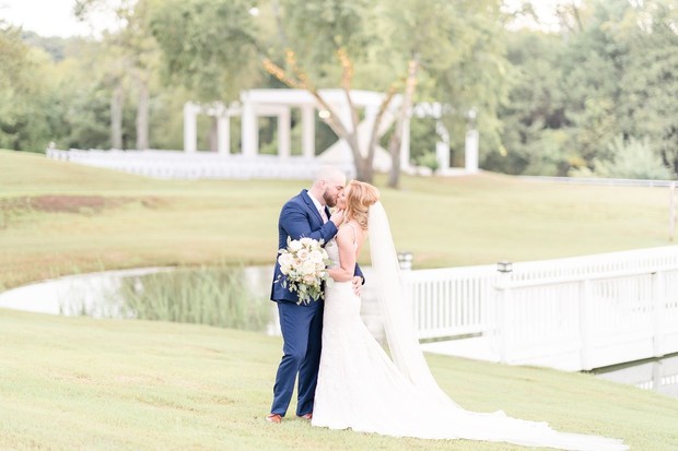 A newly married couple shares a kiss on a beautiful wedding day