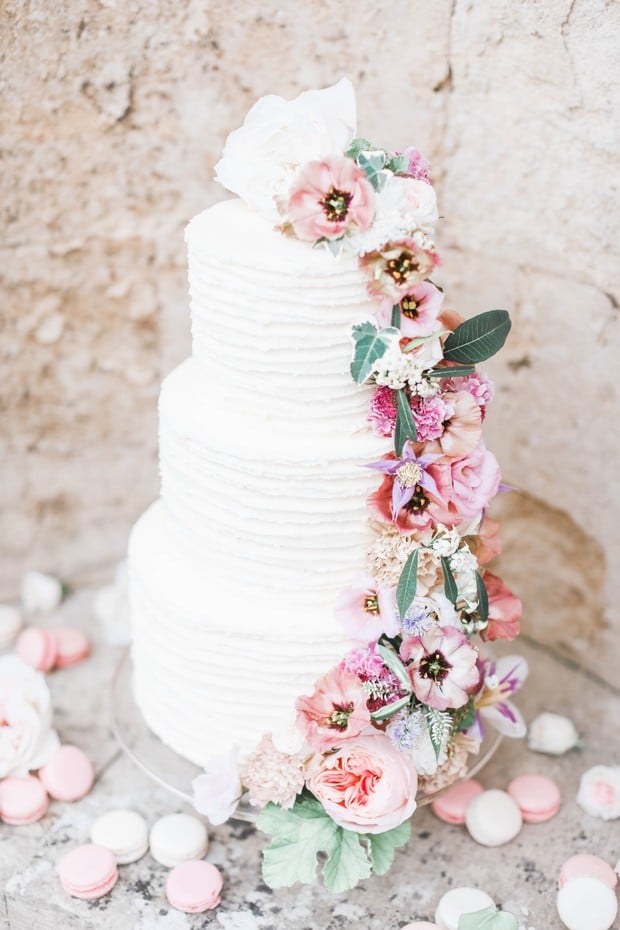 white wedding cake with cascading florals