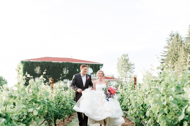 Happy couple walking in vineyard after their wedding