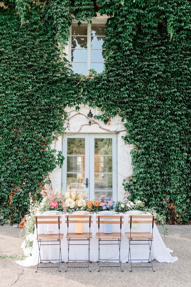 Elegant wedding table set against an ivy-covered building