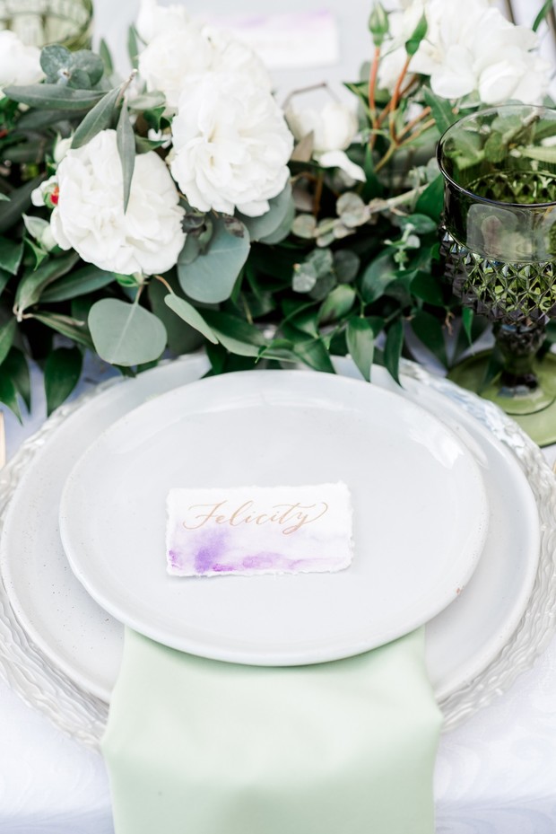 Elegant wedding table setting with white flowers and name card