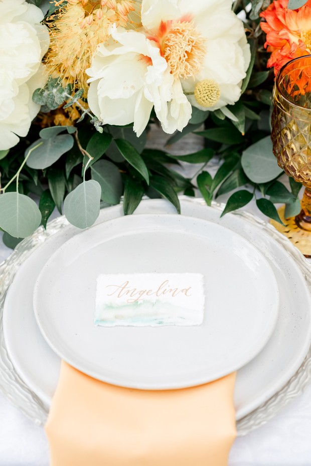 Elegant wedding place setting with floral centerpiece