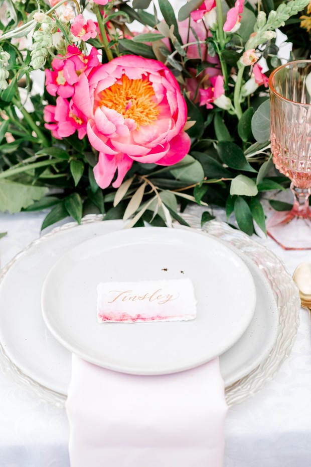 Elegant wedding place setting with pink peony flowers