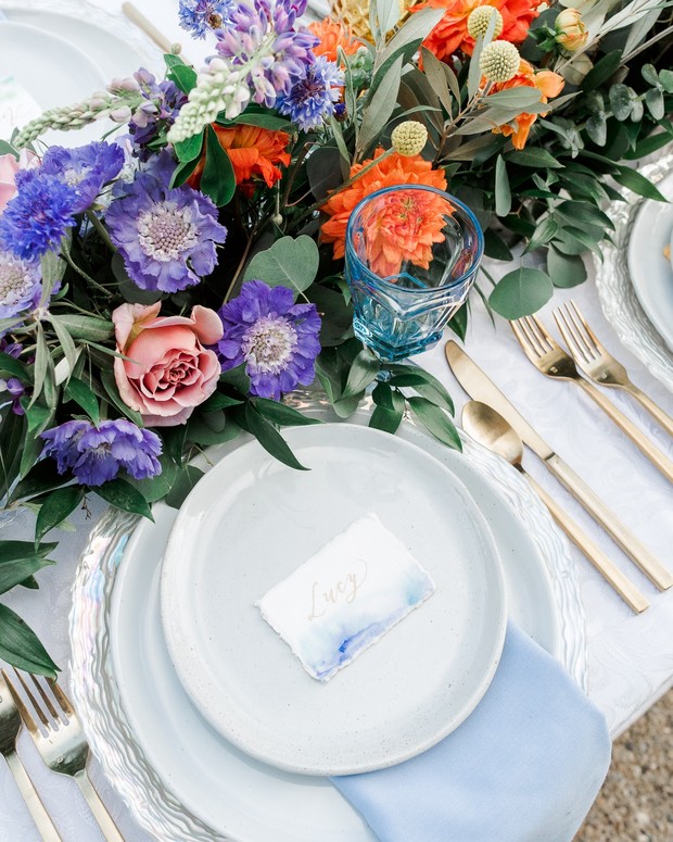 Elegant wedding table setting with colorful floral centerpiece
