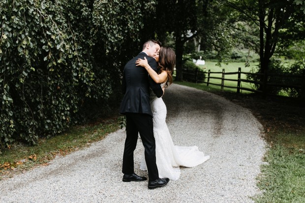Happy newlyweds embracing on their wedding day outdoors