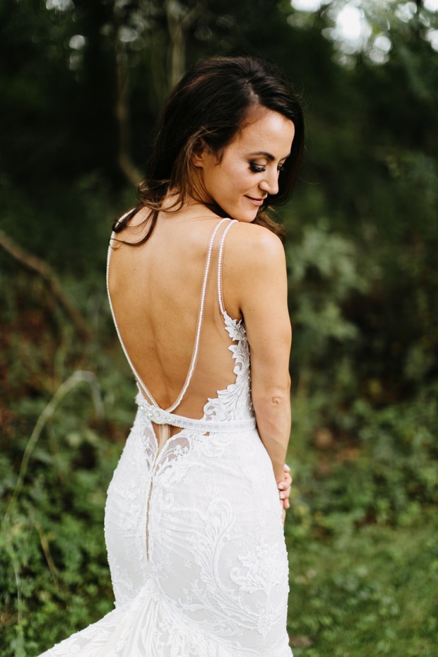Bride in a beautiful lace wedding dress with open back
