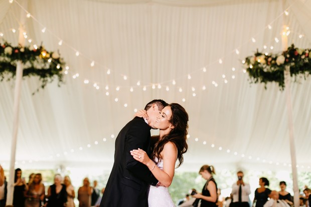 Bride and groom share a kiss during their first dance