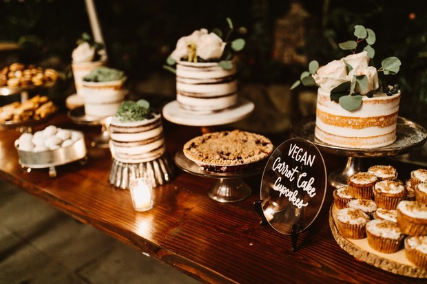 Dessert table with vegan cakes, pies, and carrot cupcakes