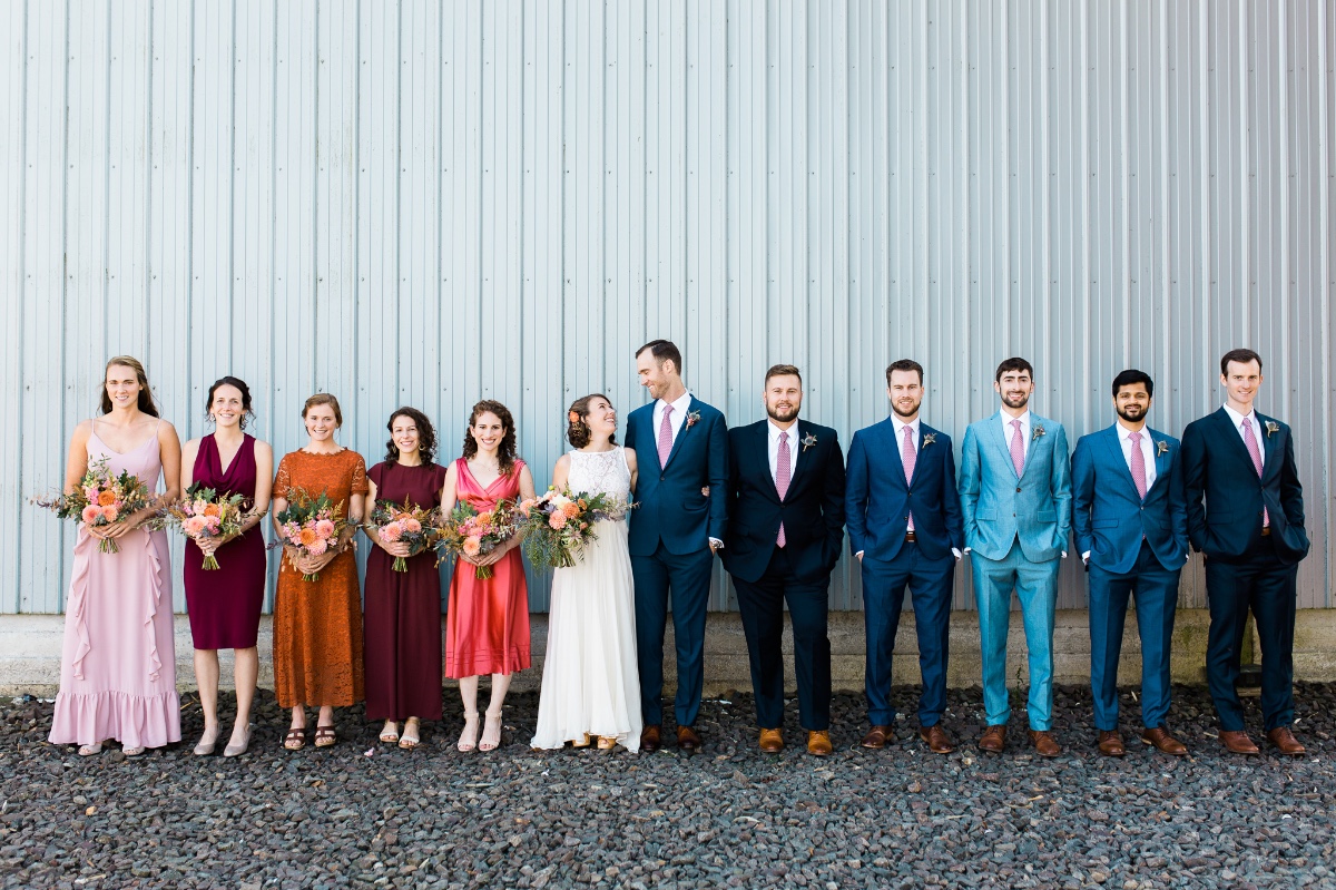 Wedding party bridesmaids and groomsmen in colorful suits