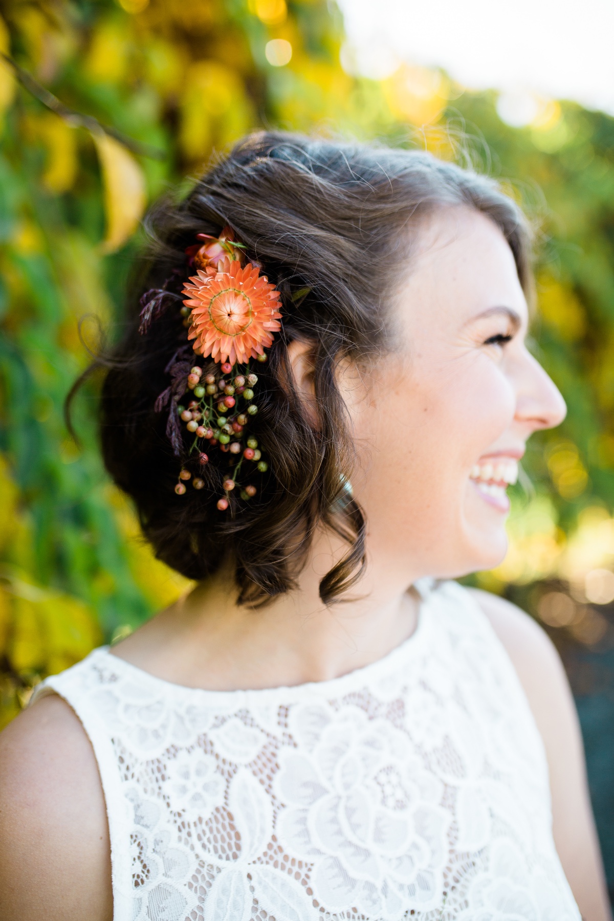 Smiling bride with flower hairpiece and lace dress