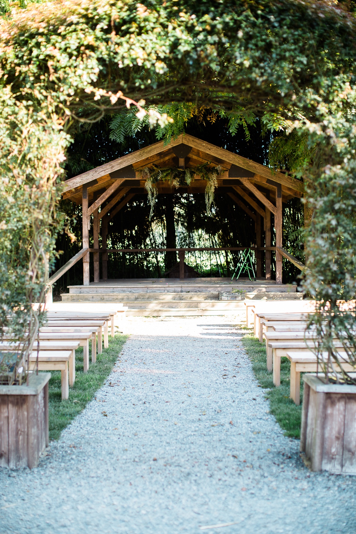 Rustic outdoor wedding ceremony aisle with benches