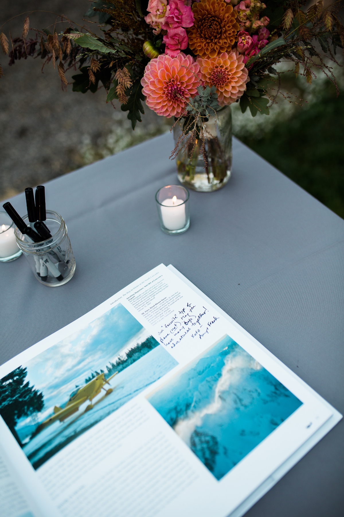 Wedding guest book table setting with flowers and candles