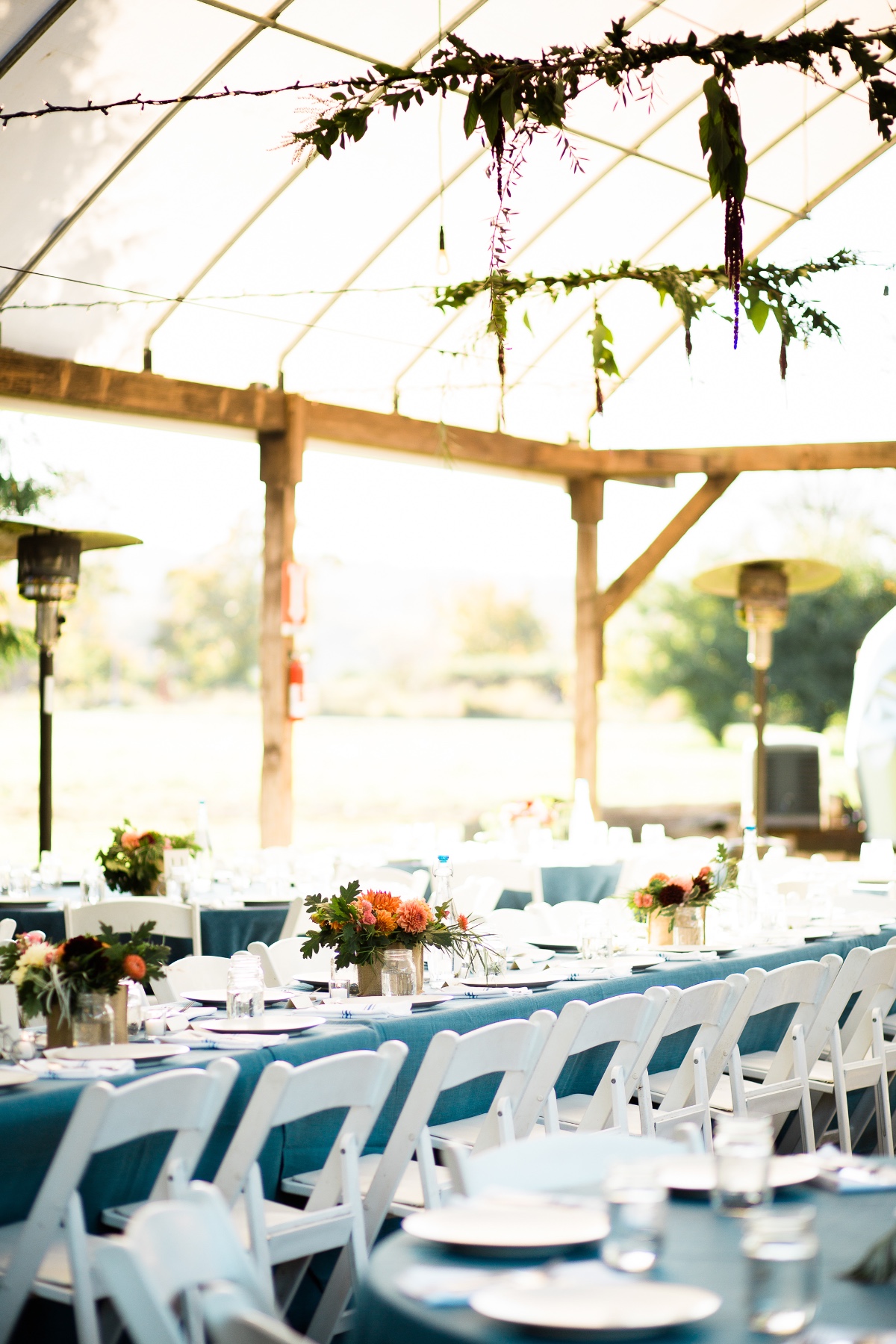 Elegant wedding reception setup with blue linens and white chairs