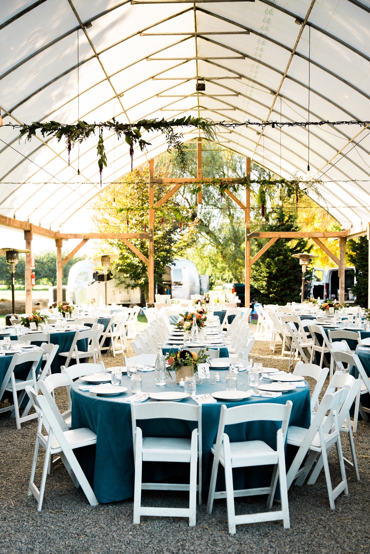 Elegant outdoor wedding reception tent with round tables