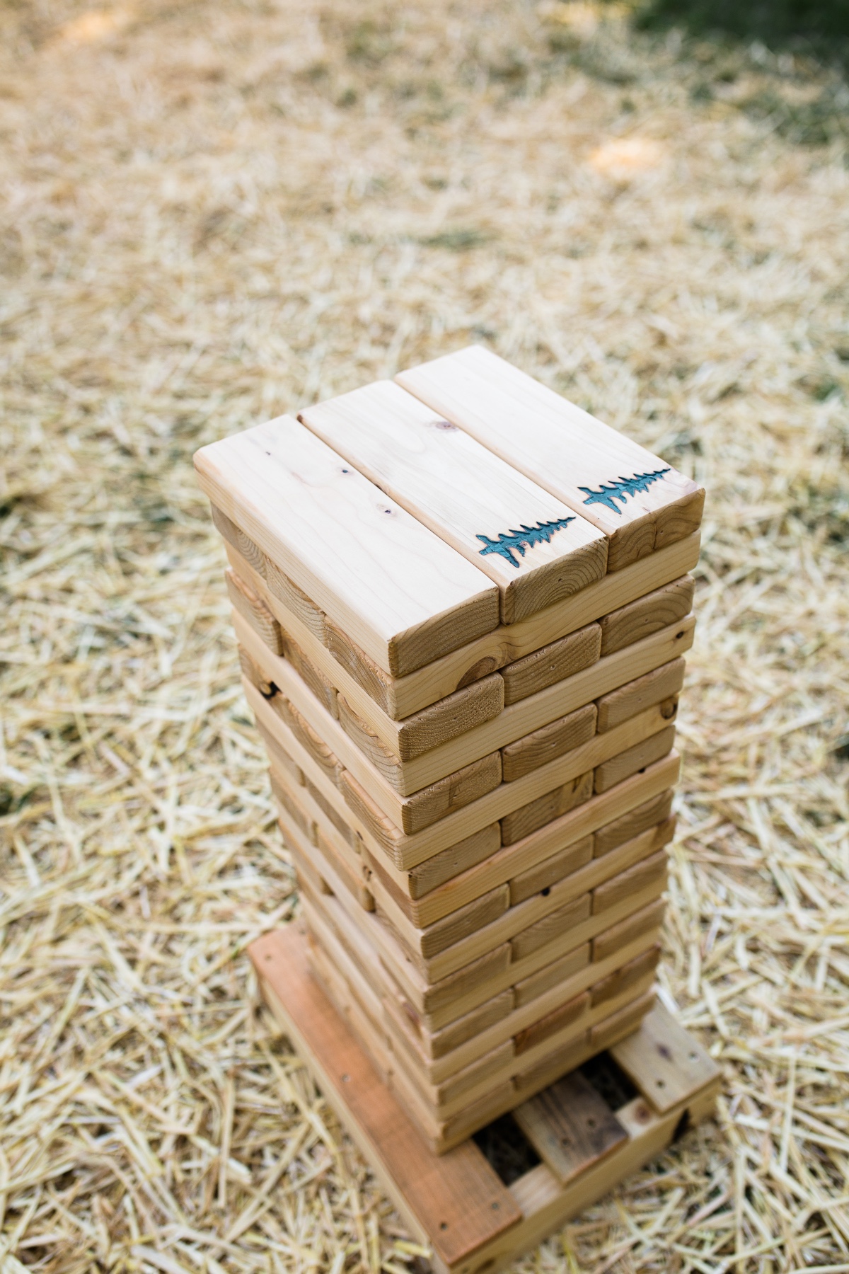 Giant Jenga game with fern design on wooden blocks