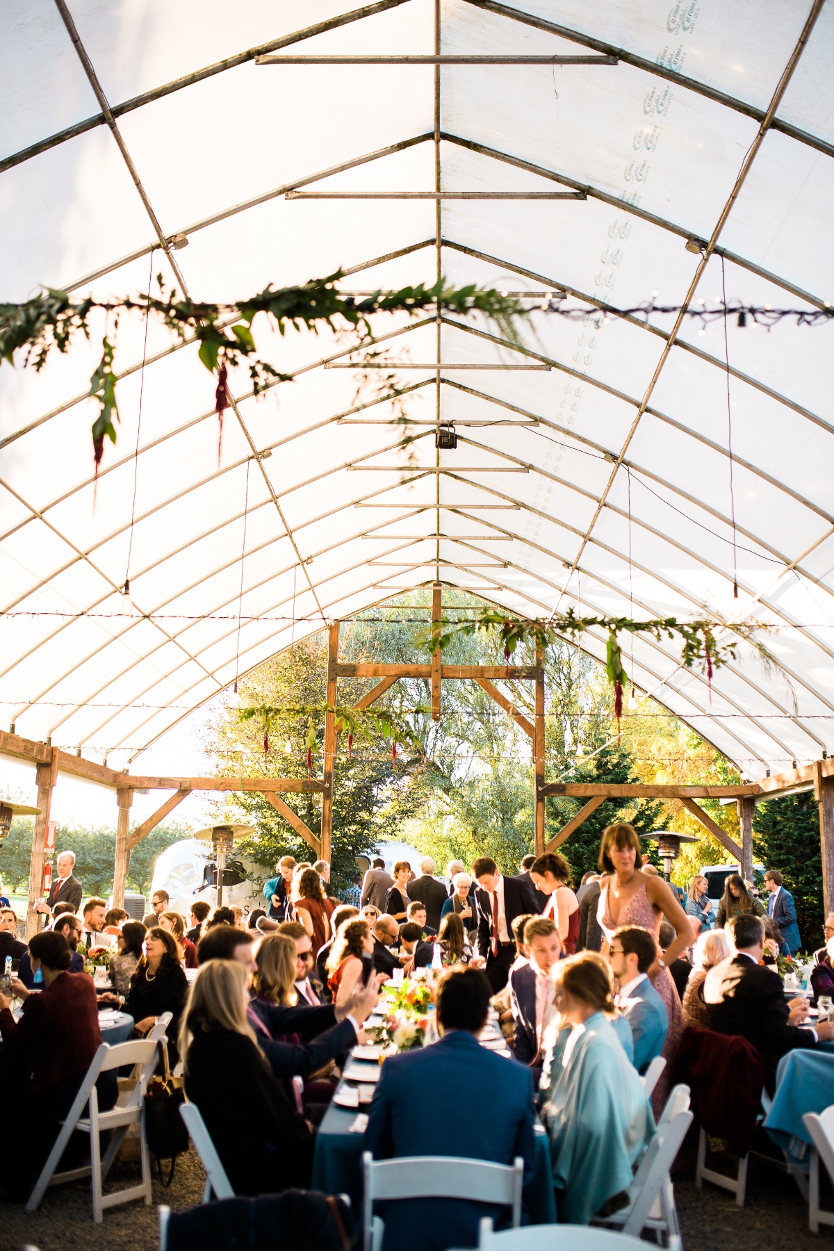 Wedding reception under a bright clear tent structure