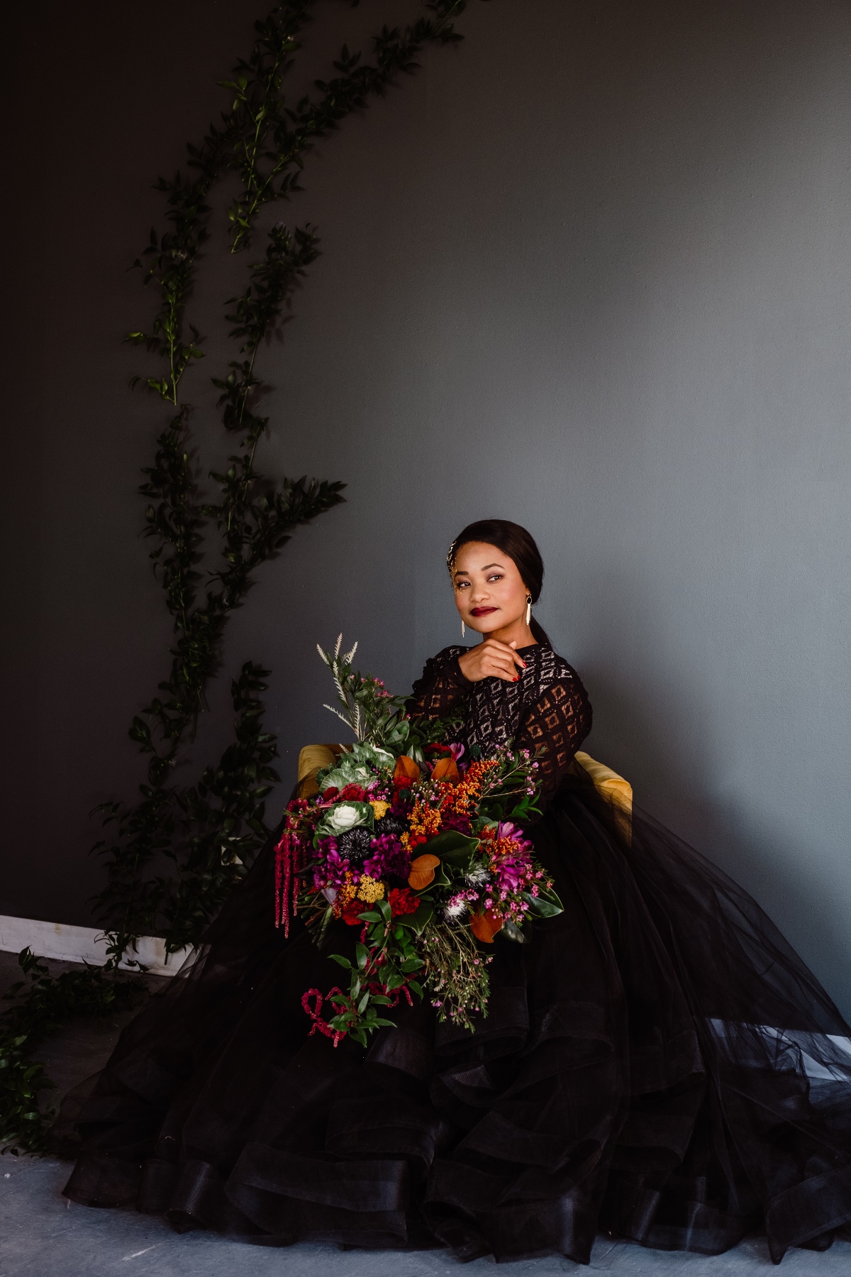 bride in black with modern colorful bouquet