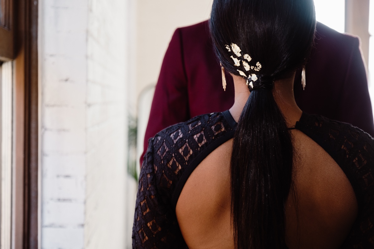 sleek low ponytail with gold leaf accents