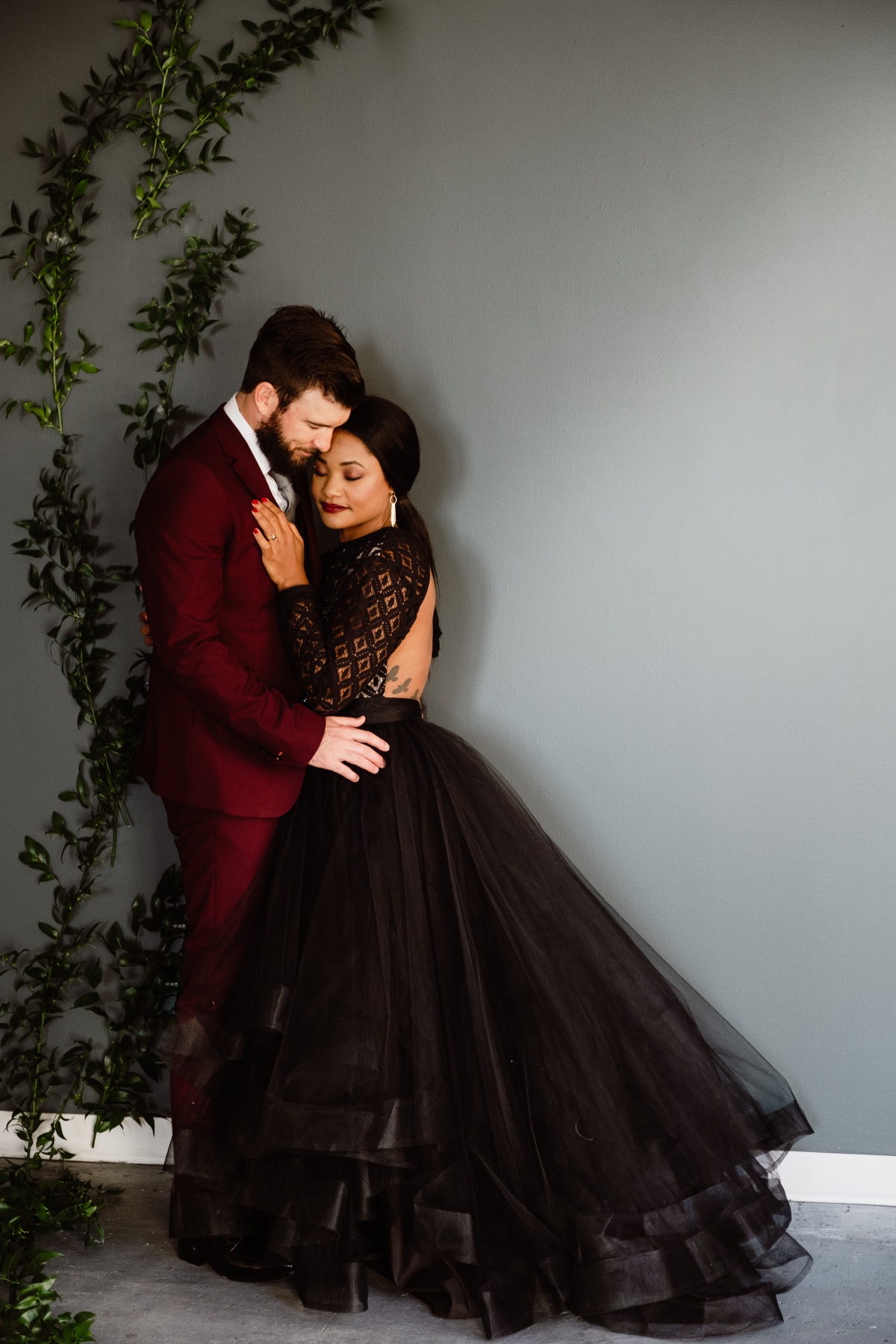 wedding couple in black and burgundy