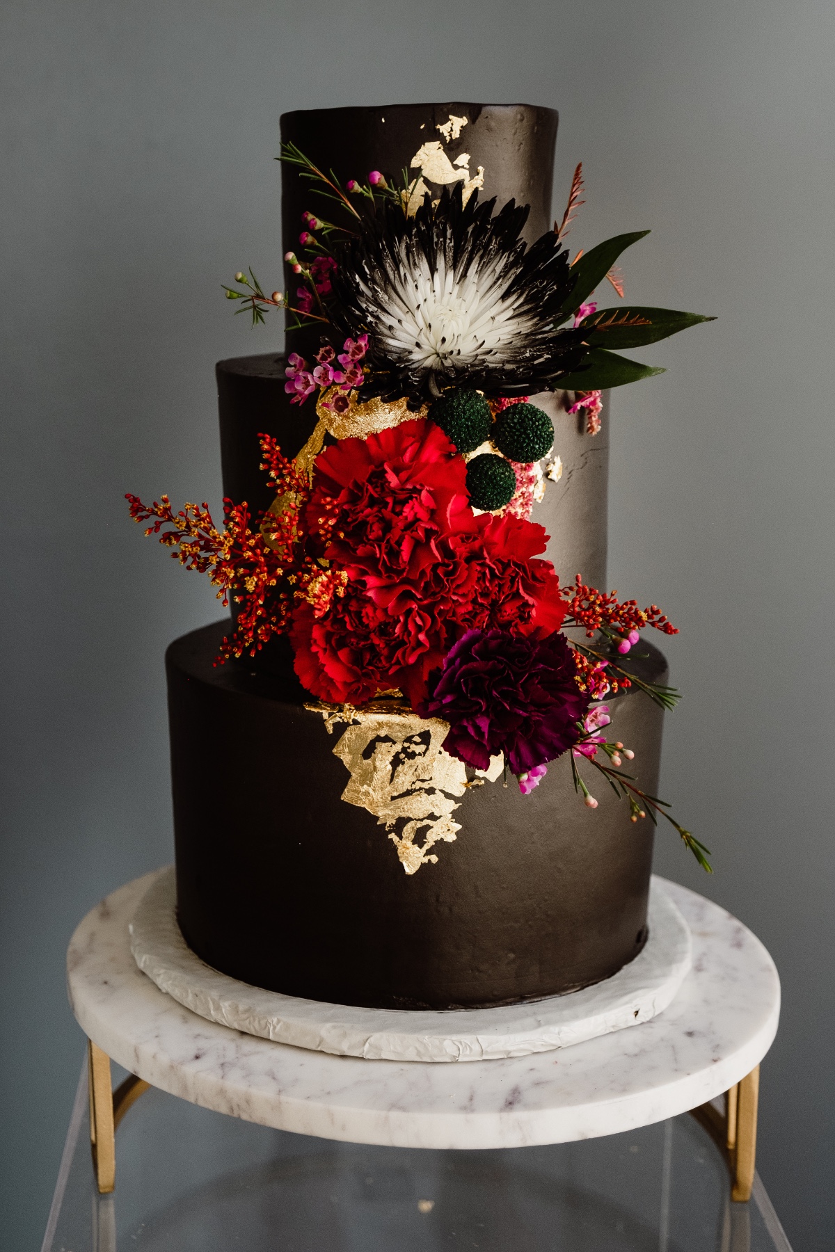 black cake with modern floral decor