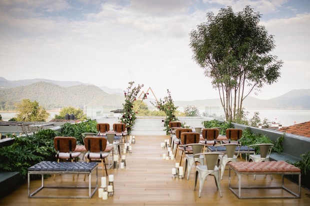 Rooftop wedding ceremony setup overlooking mountains lake