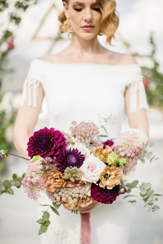 Bride holding beautiful vibrant wedding flower bouquet