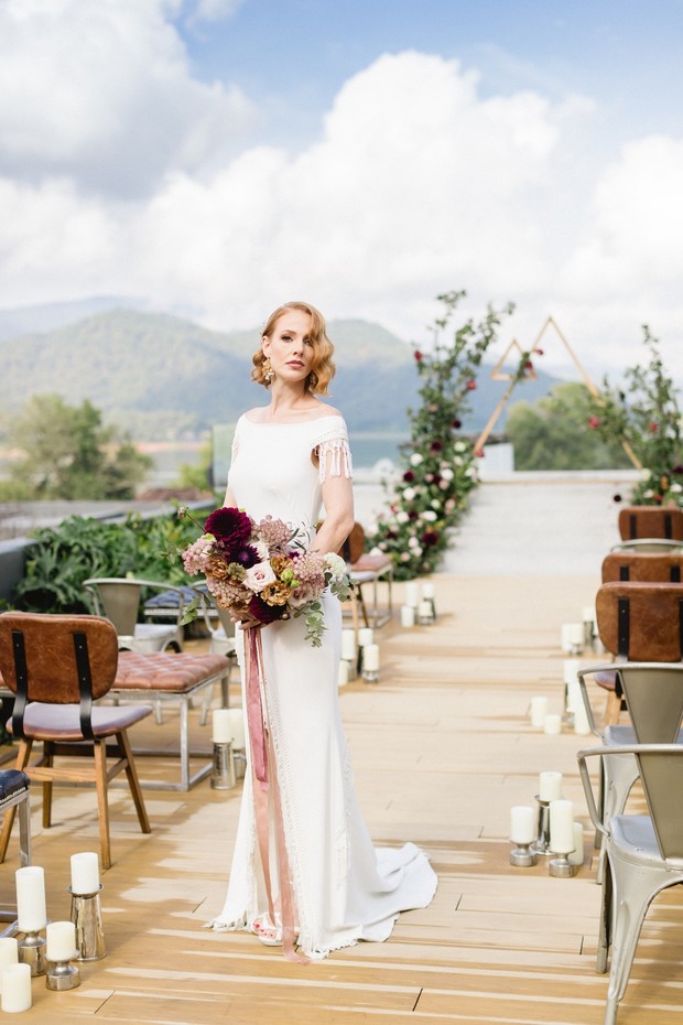 Elegant bride with bouquet at outdoor wedding ceremony
