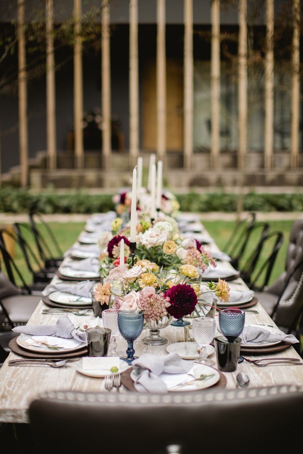 Elegant outdoor wedding reception table setting with flowers