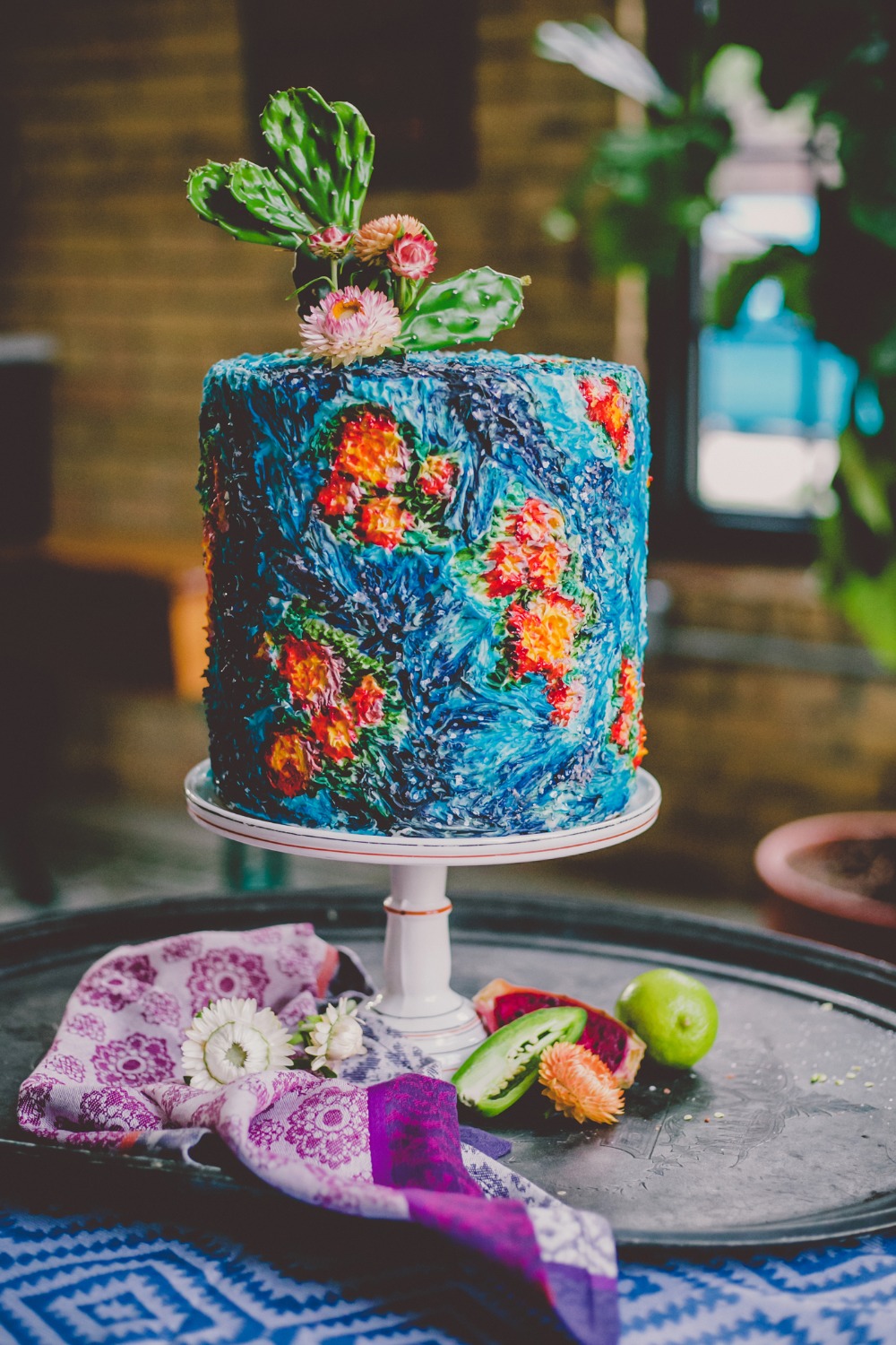 Colorful modern wedding cake with cactus topper
