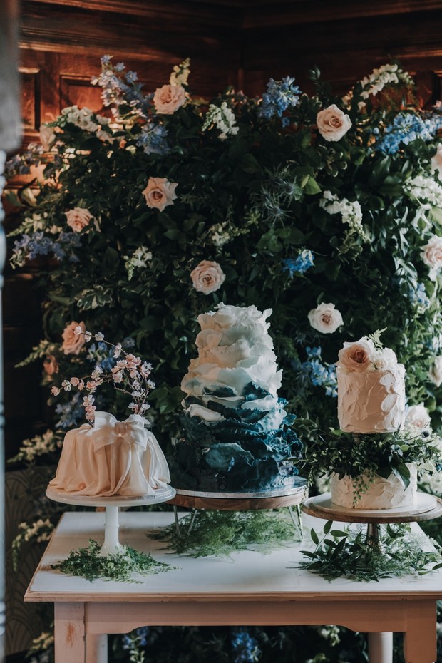 ruffled wedding cakes and floral backdrop
