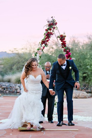 jumping over the broom stick