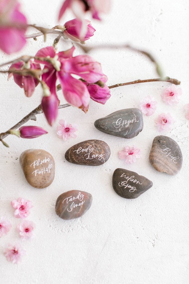 Wedding seating stones with names and floral accents