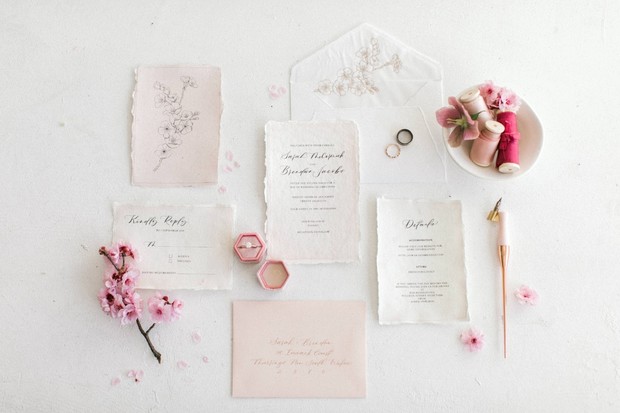 Elegant wedding invitation suite with pink floral accents
