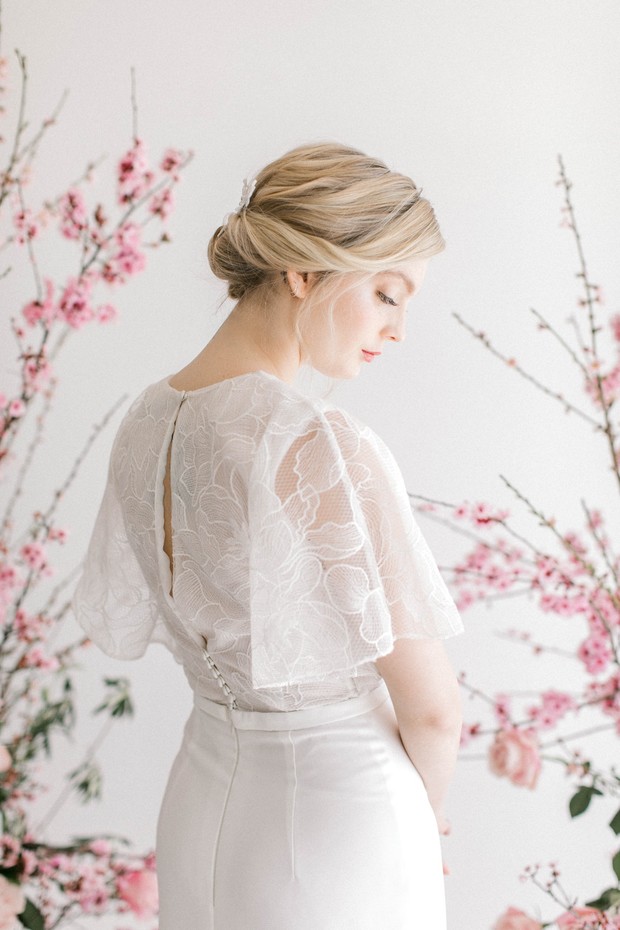 Blonde bride in white lace dress with floral accents