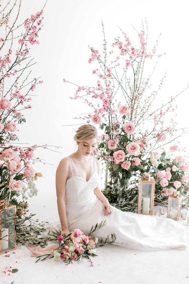 Elegant bride surrounded by pink cherry blossom blooms