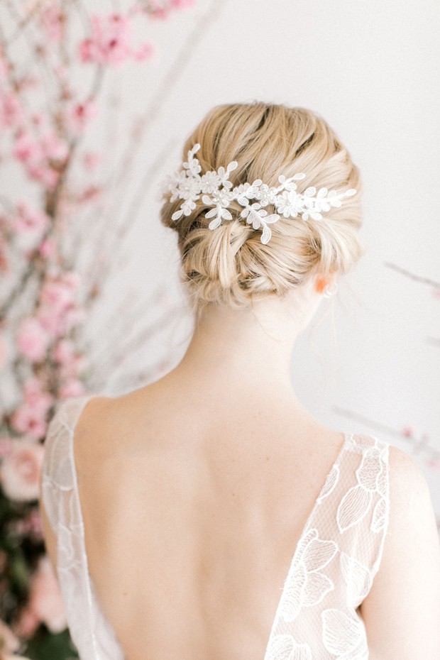 Bride wearing elegant lace hairpiece and low back dress