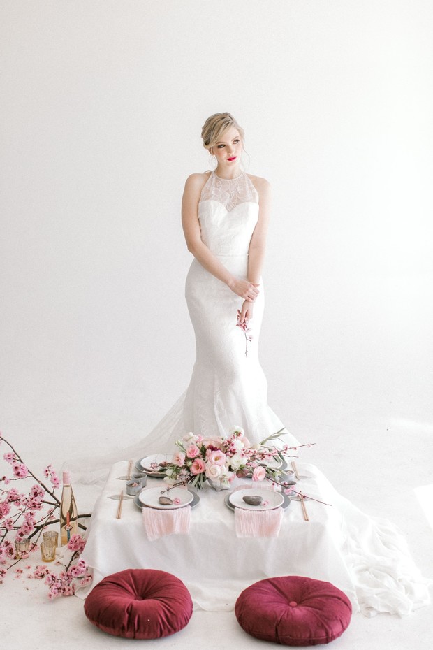 Elegant bride in white gown at a minimalist wedding table