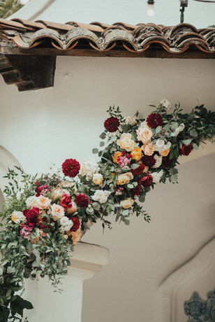 blush and burgundy wedding floral arch