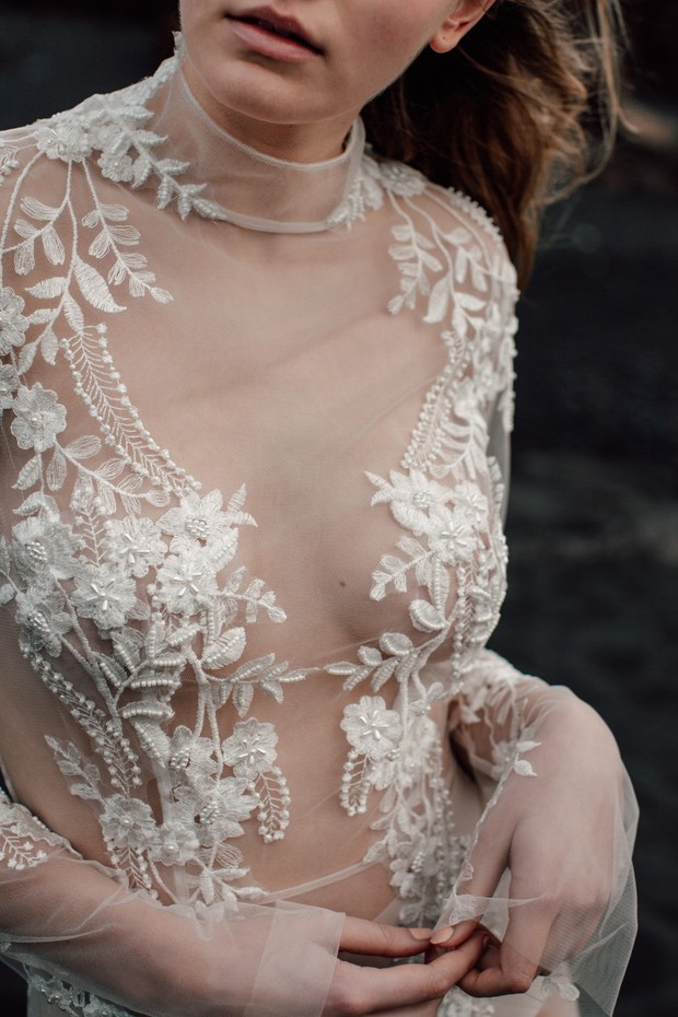 Woman in sheer wedding dress with floral embroidery