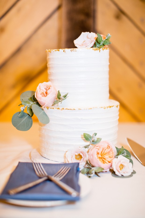 white wedding cake with gold flake