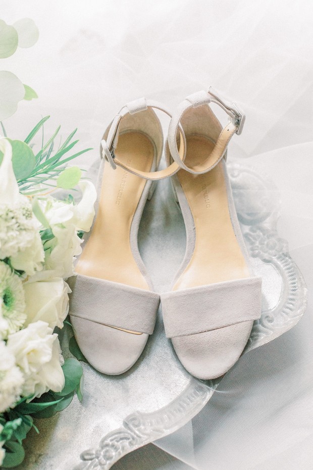 Elegant grey wedding heels and white floral bouquet