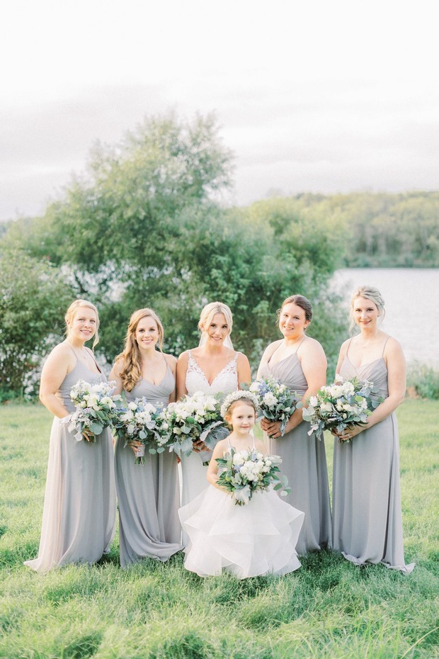 Bride and bridesmaids in gray dresses with bouquets