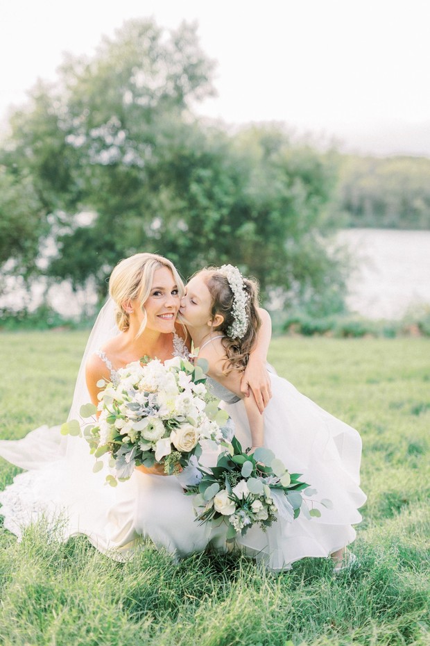 Bride with flower girl at outdoor wedding ceremony
