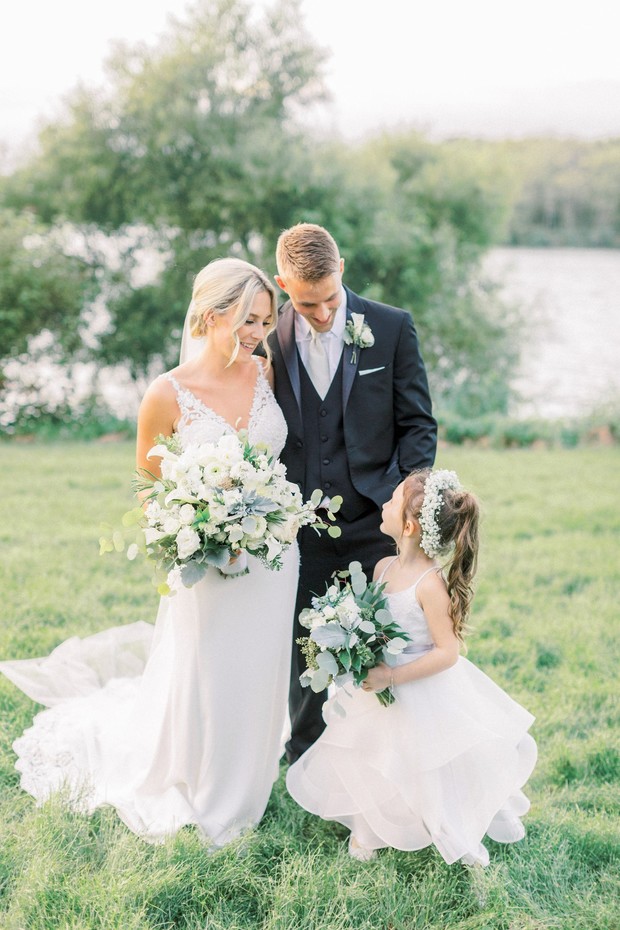 Bride groom and flower girl at outdoor wedding venue