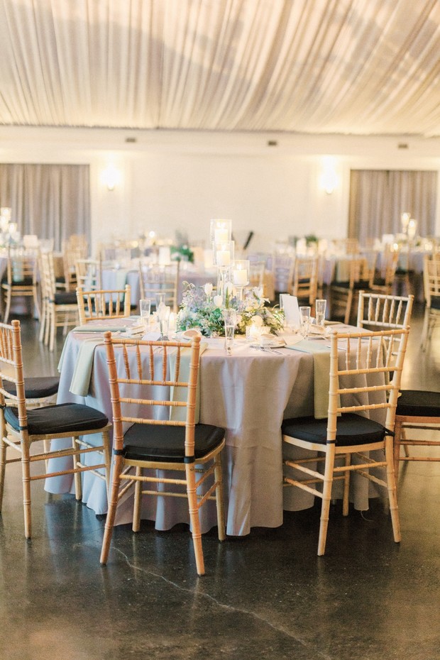 Elegant wedding reception table with stylish chairs and decor